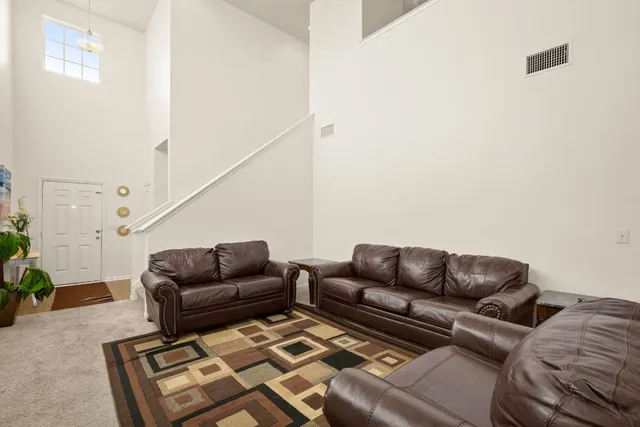 a living room with furniture a couch and with potted plants