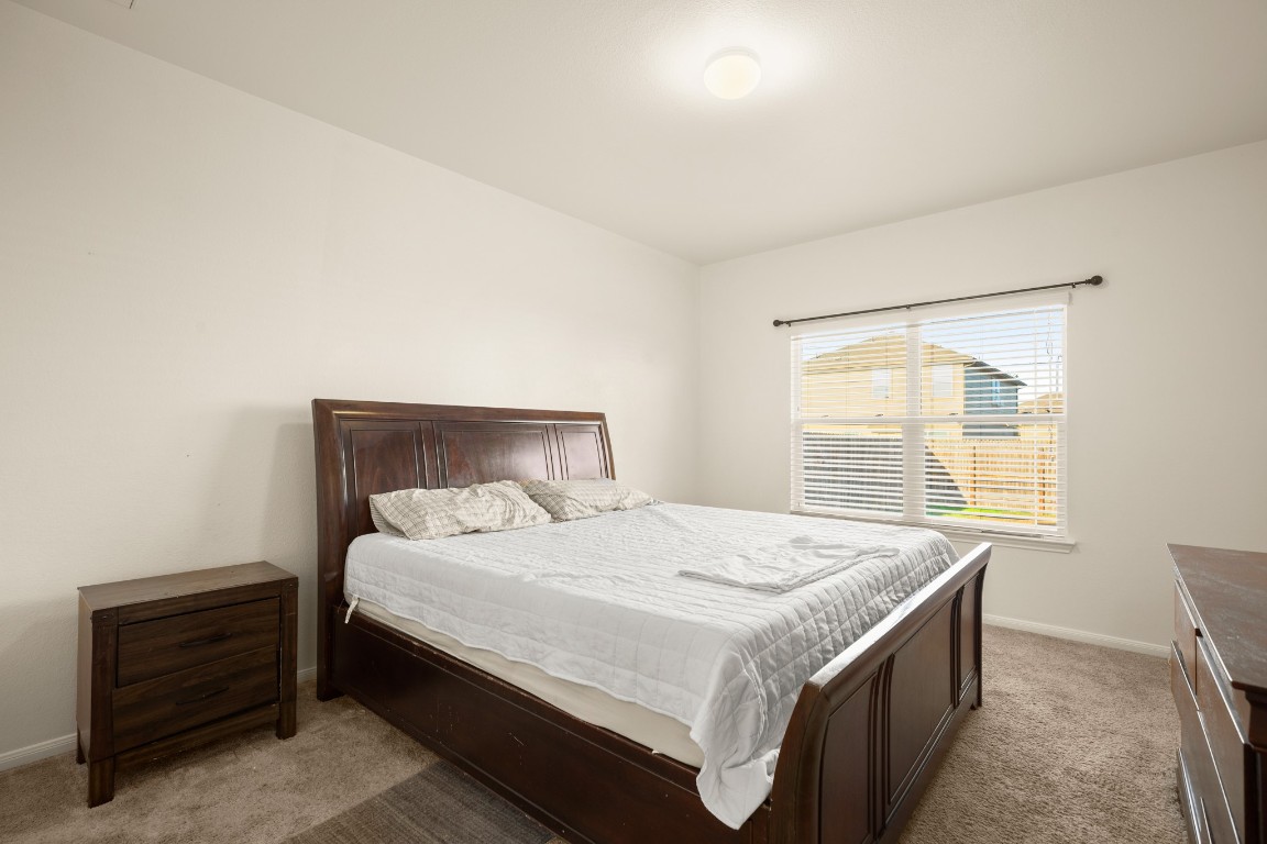 14504 Callan Court Manor, TX 78653 - Photo 10 of 22 a bedroom with a bed and a window