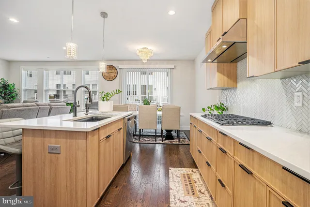 a kitchen with stainless steel appliances a sink stove and cabinets