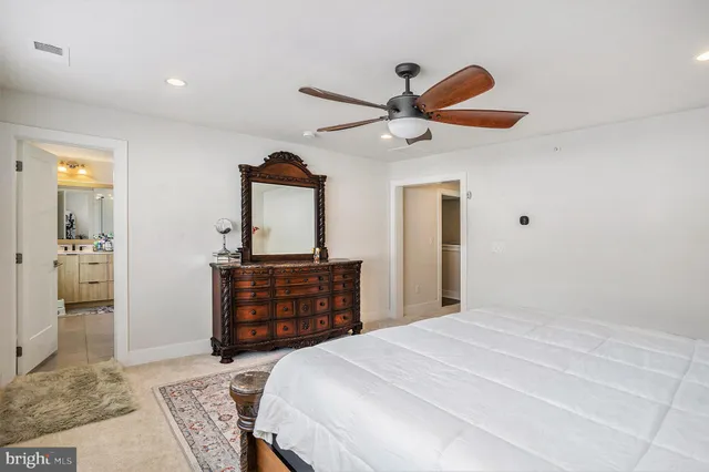 a bedroom with a bed and a dresser