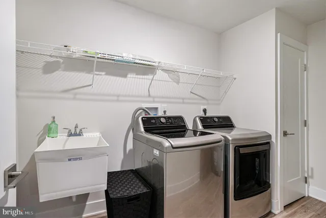 a utility room with sink dryer and washer