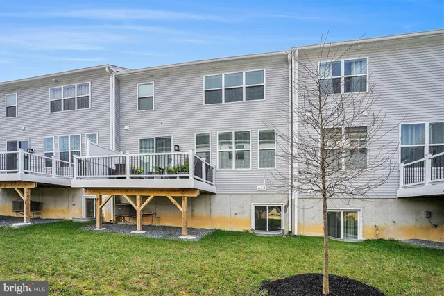 a view of a house with a swimming pool and a yard