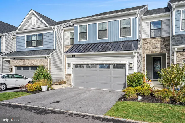 a view of a house with a yard and a garage