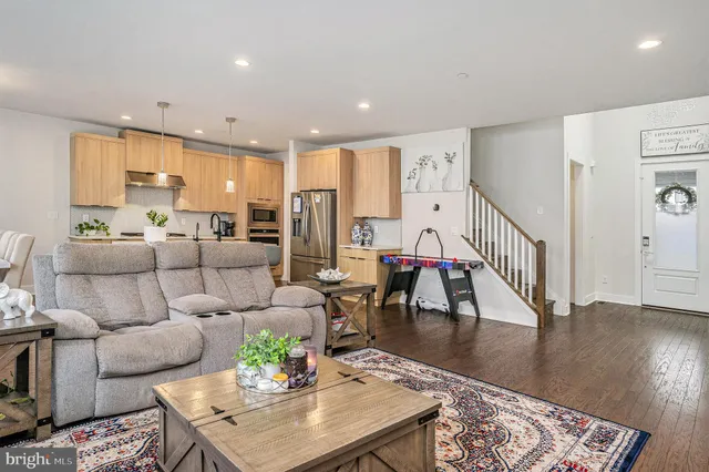 a living room with furniture wooden floor and a table