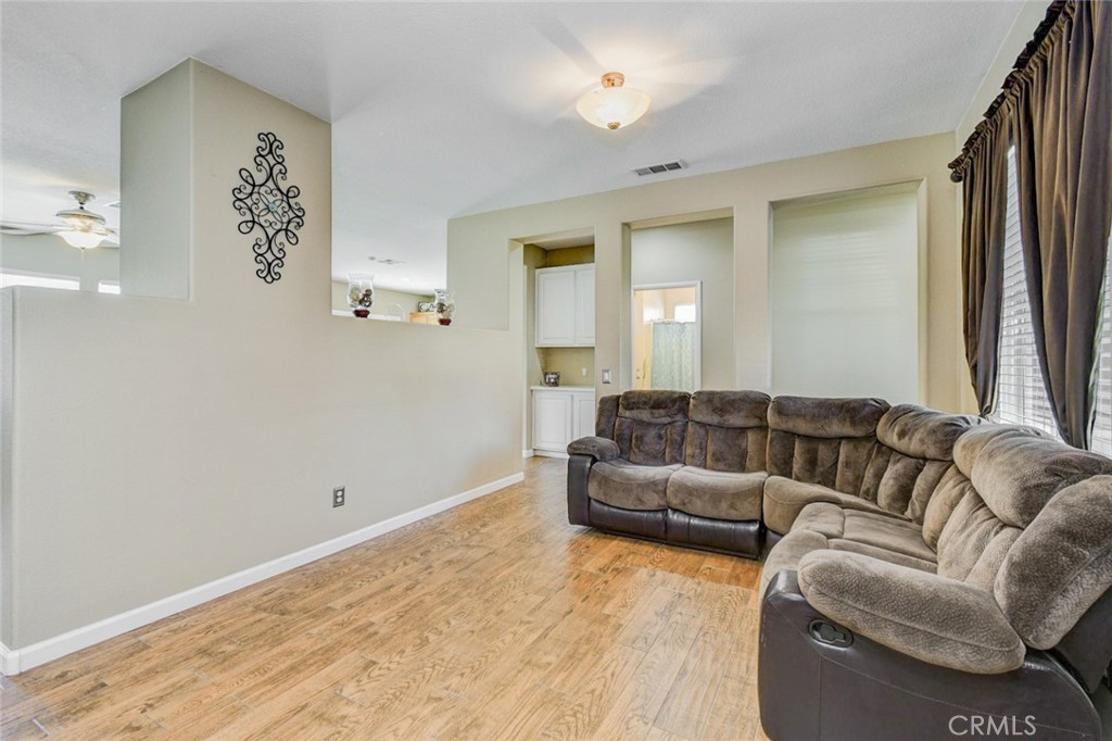 6174 Risingstar Drive Eastvale, CA 92880 - Photo 16 of 57 a living room with furniture and a flat screen tv