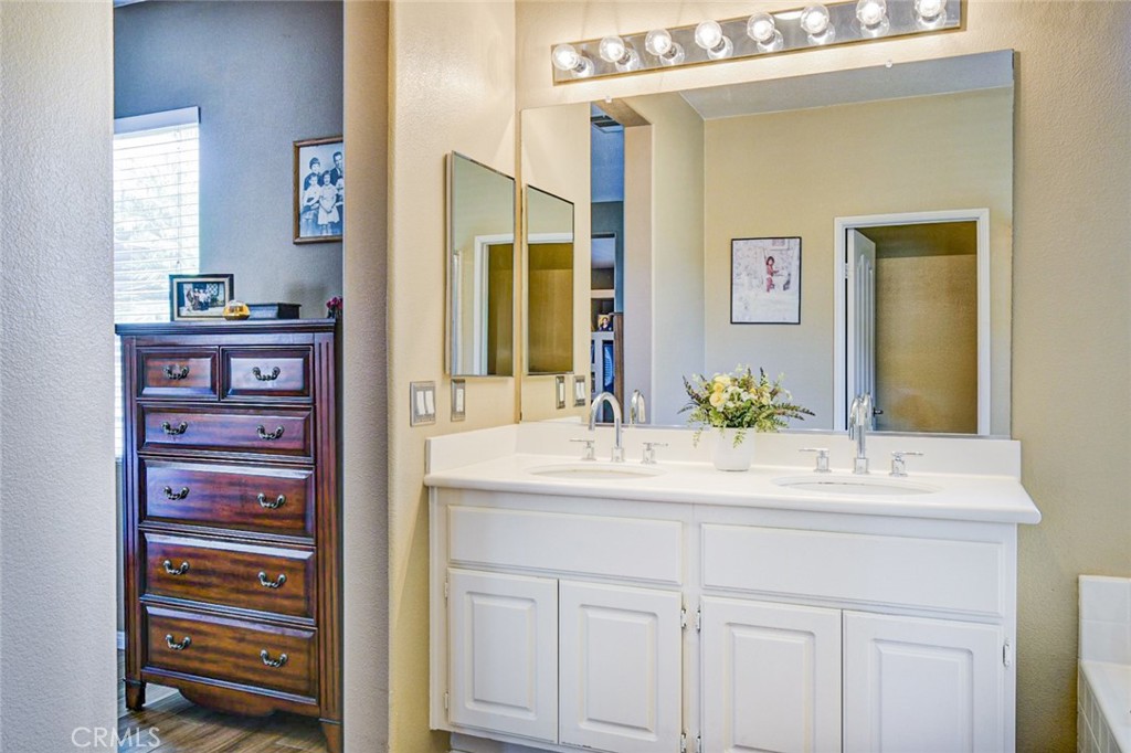 6174 Risingstar Drive Eastvale, CA 92880 - Photo 20 of 57 a bathroom with a sink vanity and a mirror
