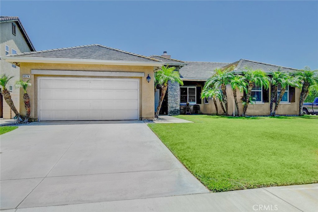 6174 Risingstar Drive Eastvale, CA 92880 - Photo 2 of 57 a front view of house with yard