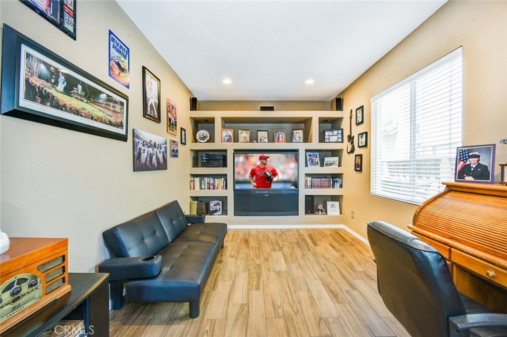 6174 Risingstar Drive Eastvale, CA 92880 - Photo 23 of 57 a living room with furniture and a flat screen tv