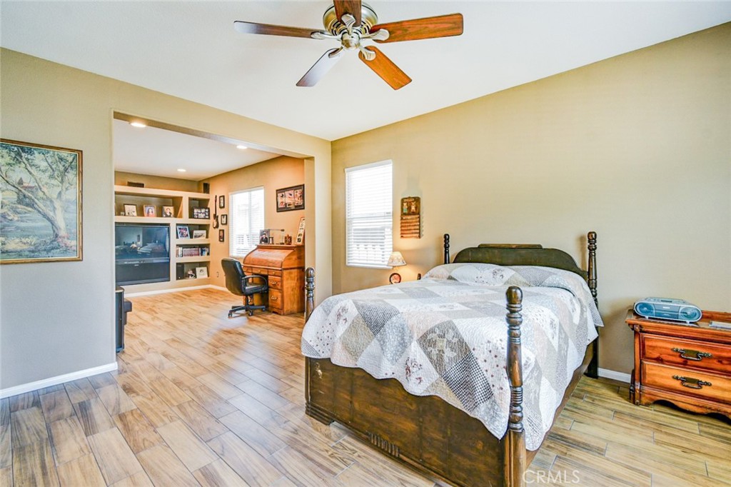 6174 Risingstar Drive Eastvale, CA 92880 - Photo 28 of 57 a spacious bedroom with a bed and wooden floor
