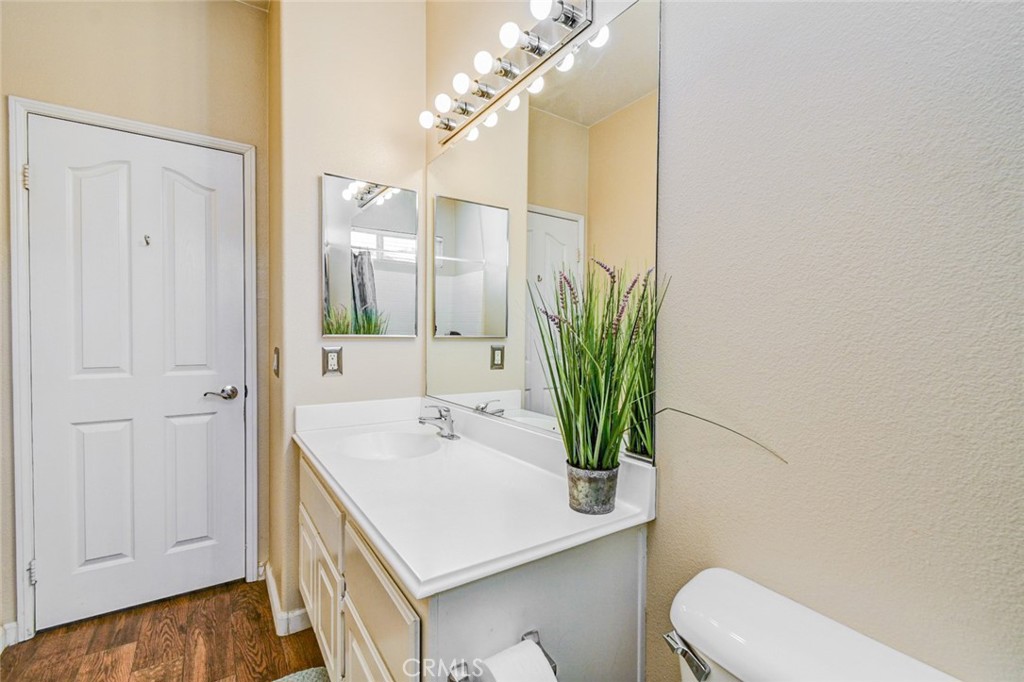 6174 Risingstar Drive Eastvale, CA 92880 - Photo 29 of 57 a bathroom with a sink a toilet and shower