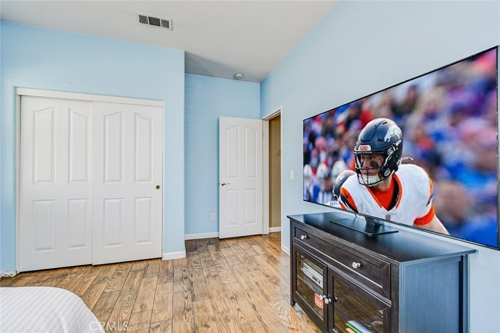 6174 Risingstar Drive Eastvale, CA 92880 - Photo 30 of 57 a bedroom with a bed and a painting on the wall