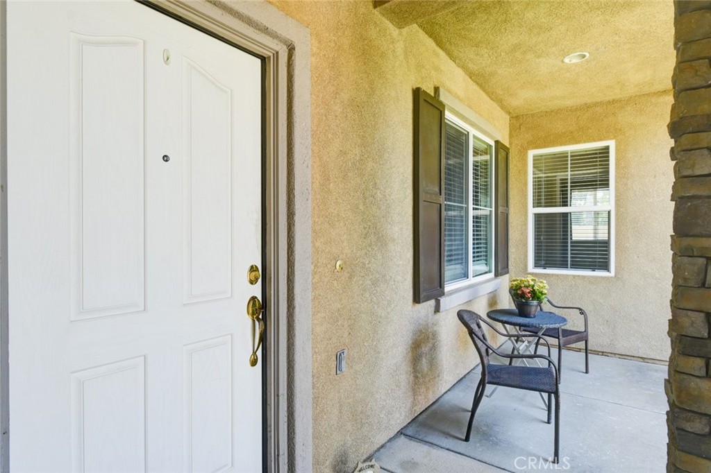 6174 Risingstar Drive Eastvale, CA 92880 - Photo 3 of 57 a view of a hallway with furniture and front door