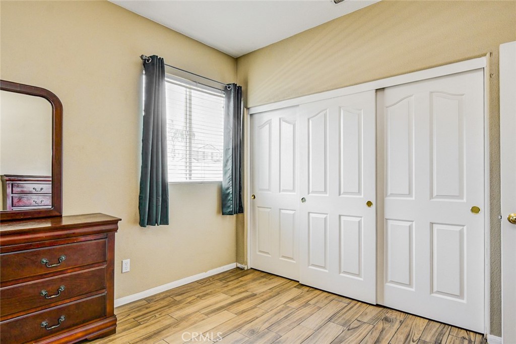 6174 Risingstar Drive Eastvale, CA 92880 - Photo 31 of 57 a view of a room with wooden floor and cabinet