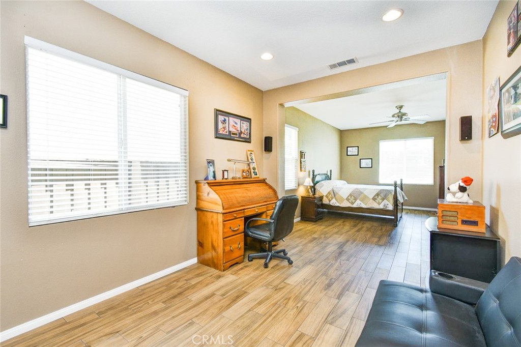 6174 Risingstar Drive Eastvale, CA 92880 - Photo 34 of 57 a bedroom with furniture and a wooden floor