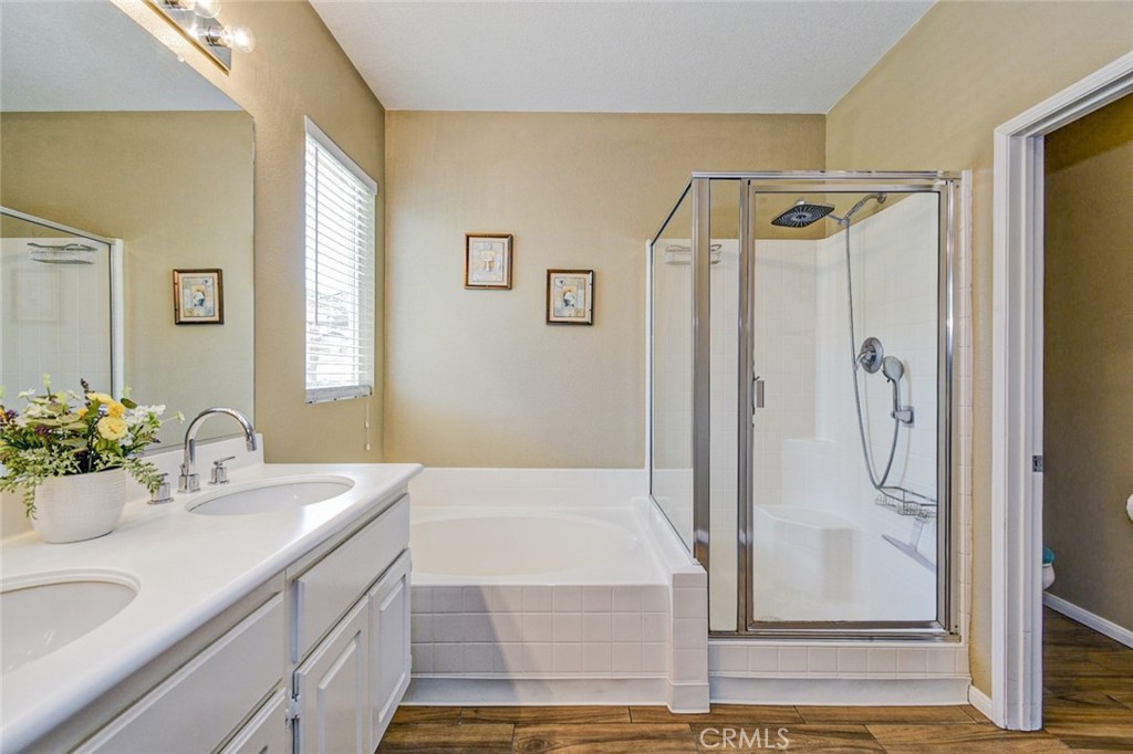 6174 Risingstar Drive Eastvale, CA 92880 - Photo 37 of 57 a bathroom with a granite countertop sink and a mirror