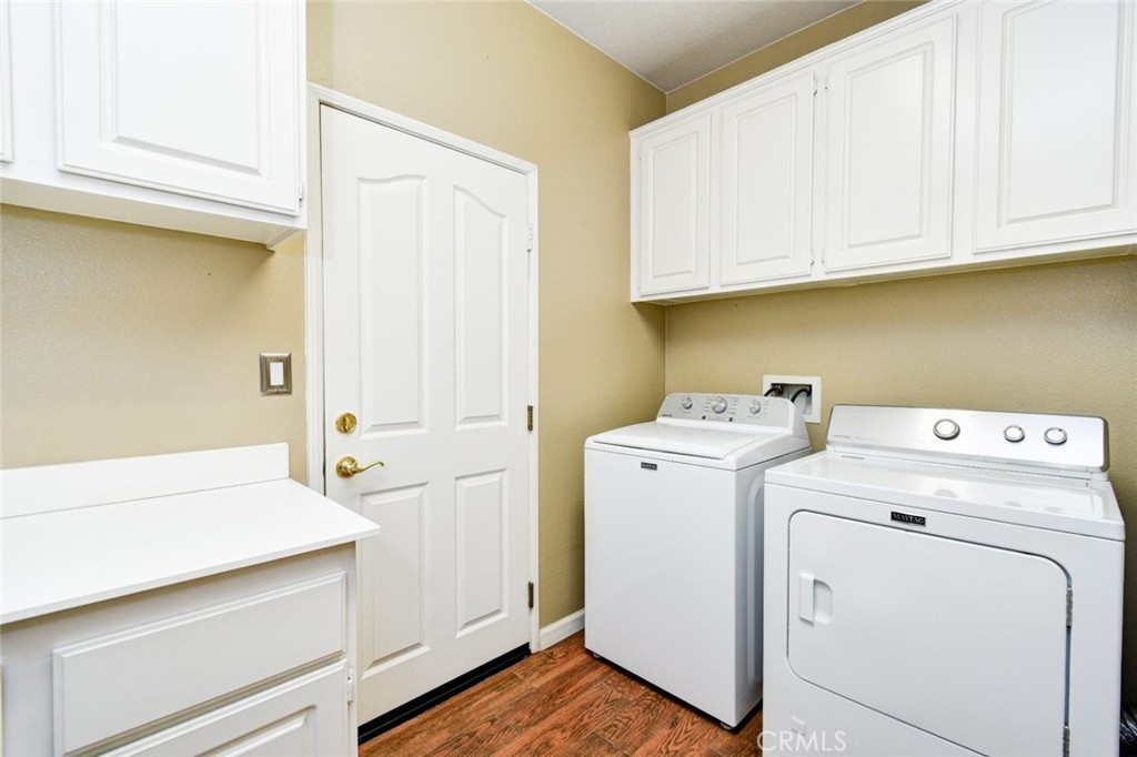 6174 Risingstar Drive Eastvale, CA 92880 - Photo 39 of 57 a utility room with dryer and washer