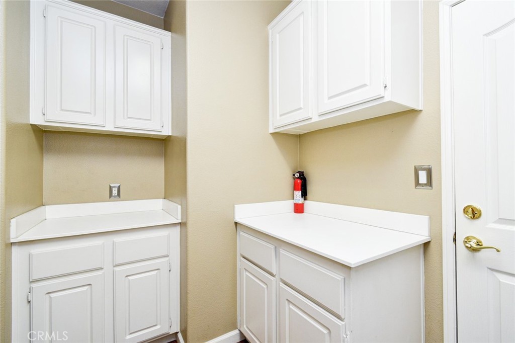 6174 Risingstar Drive Eastvale, CA 92880 - Photo 40 of 57 a bathroom with a sink and a cabinets