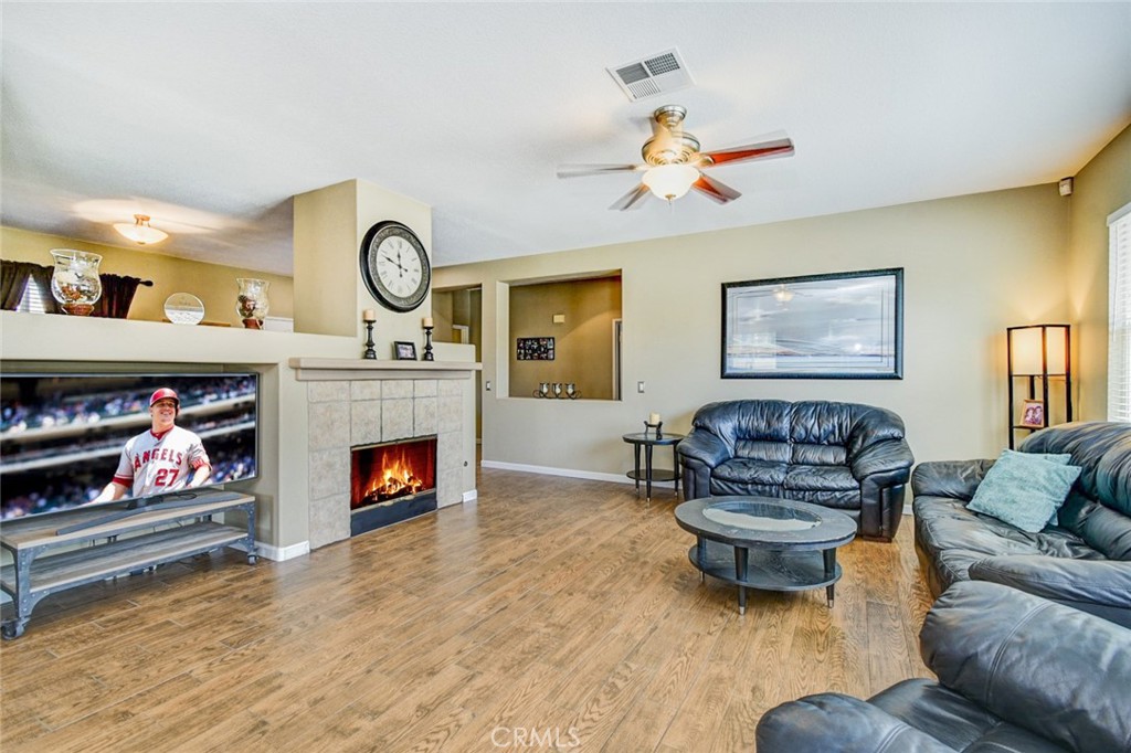 6174 Risingstar Drive Eastvale, CA 92880 - Photo 4 of 57 a living room with furniture and a fireplace