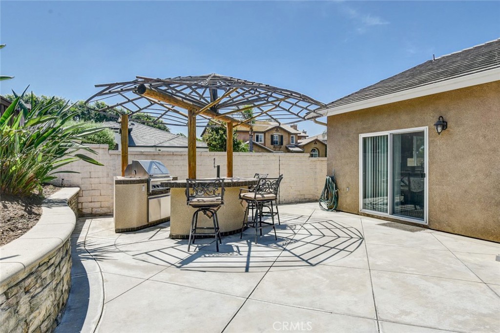6174 Risingstar Drive Eastvale, CA 92880 - Photo 46 of 57 a patio with a table and chairs