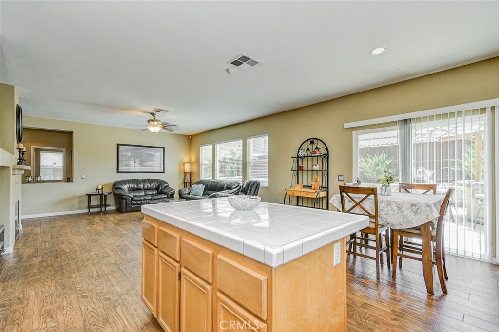 6174 Risingstar Drive Eastvale, CA 92880 - Photo 9 of 57 a view of a dining room with furniture window and wooden floor