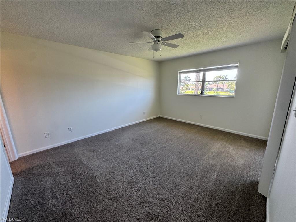 5667 Rattlesnake Hamm Road North, Unit B301 Naples, FL 34113 - Photo 8 of 17 an empty room with windows and fan