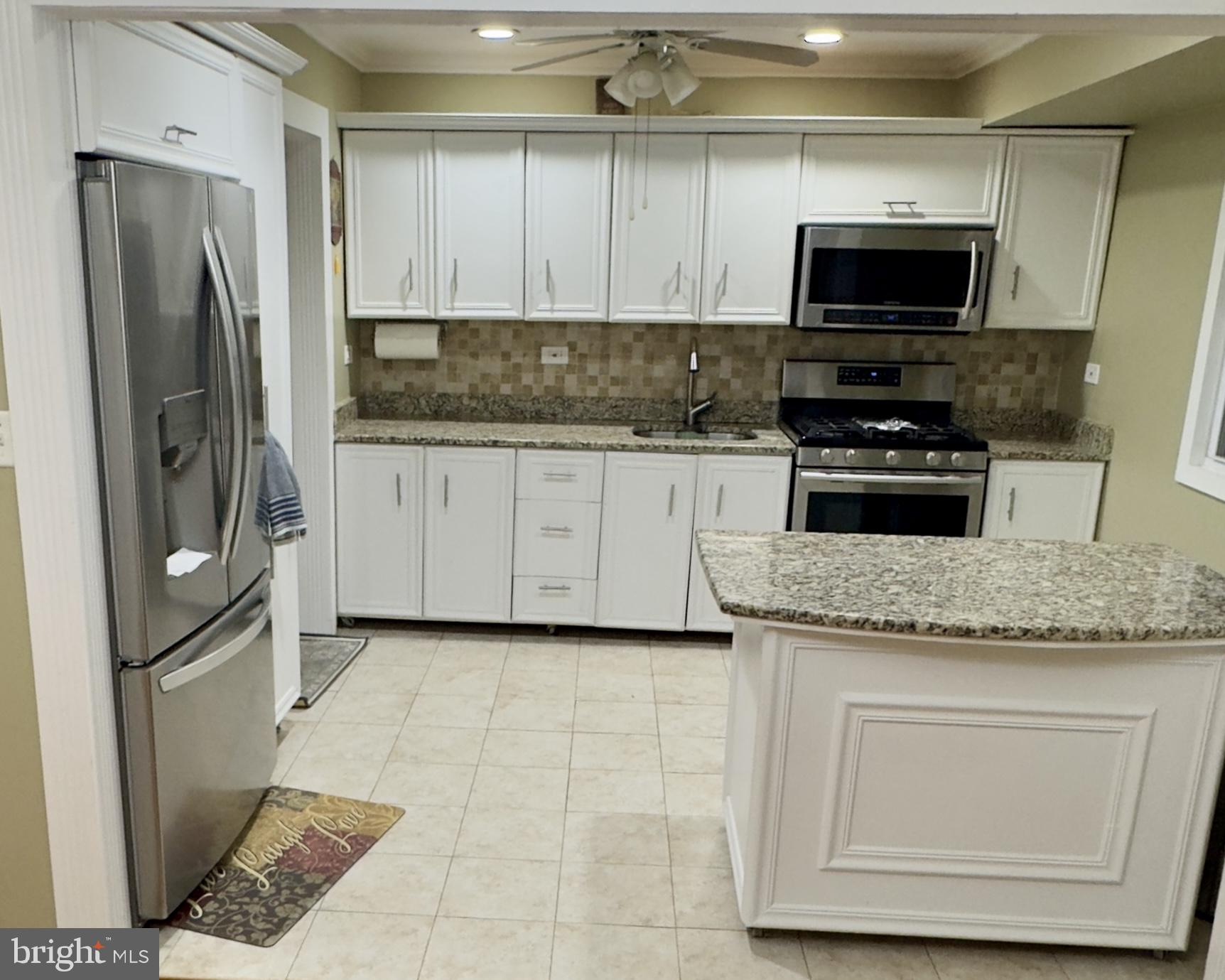 858 Estates Boulevard Hamilton, NJ 08690 - Photo 5 of 10 a kitchen with stainless steel appliances granite countertop a refrigerator stove and microwave