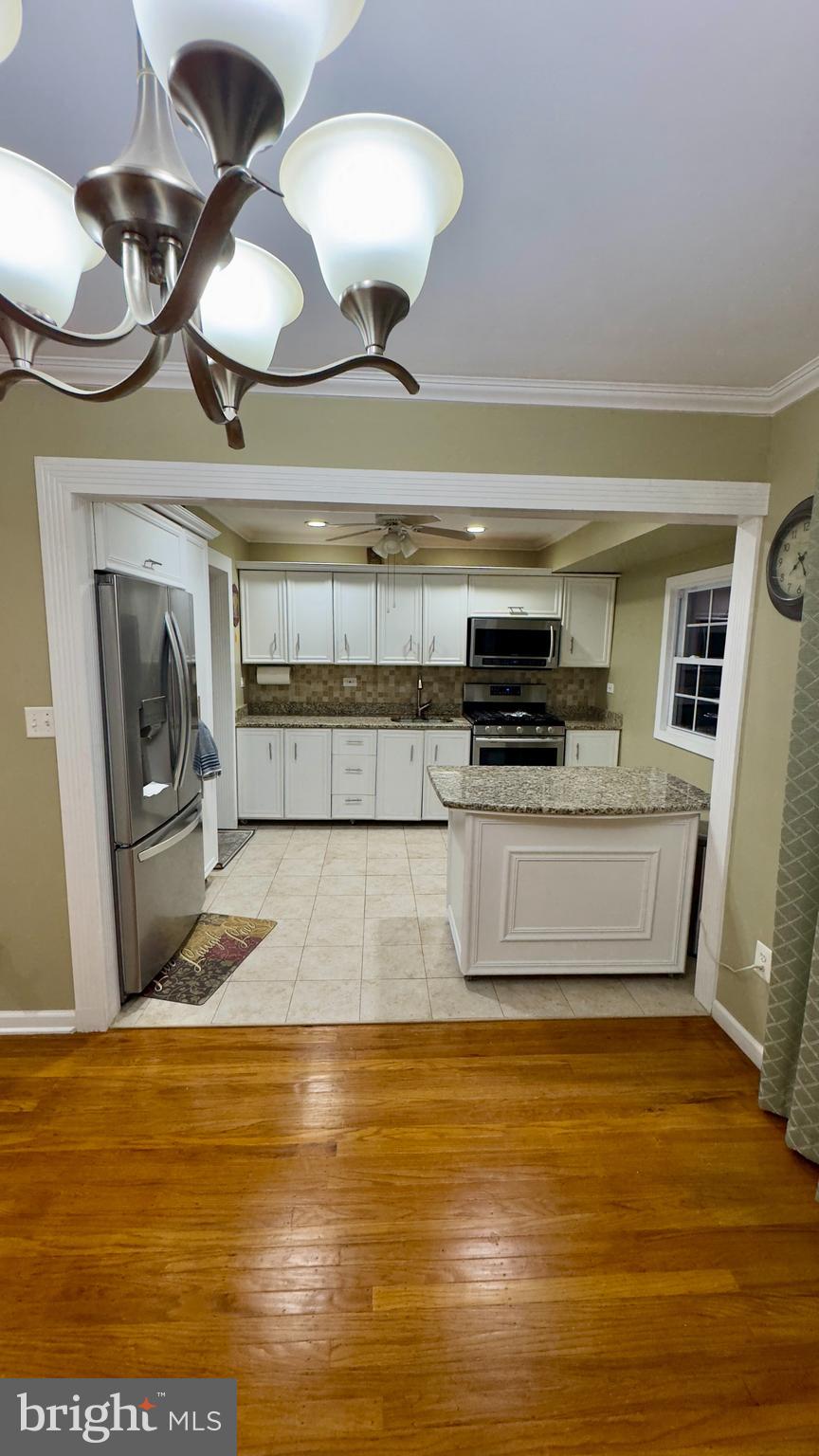 858 Estates Boulevard Hamilton, NJ 08690 - Photo 6 of 10 a living room with fireplace furniture and a wooden floor