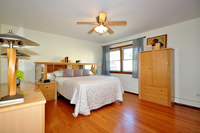 50 West Avenue, Unit 2N Riverside, IL 60546 - Photo 13 of 18 a spacious bedroom with a bed and a chandelier