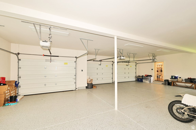 180 Farm Road Midway, UT 84049 - Photo 96 of 99 Three-car garage featuring automatic garage door openers and an epoxy-coated floor