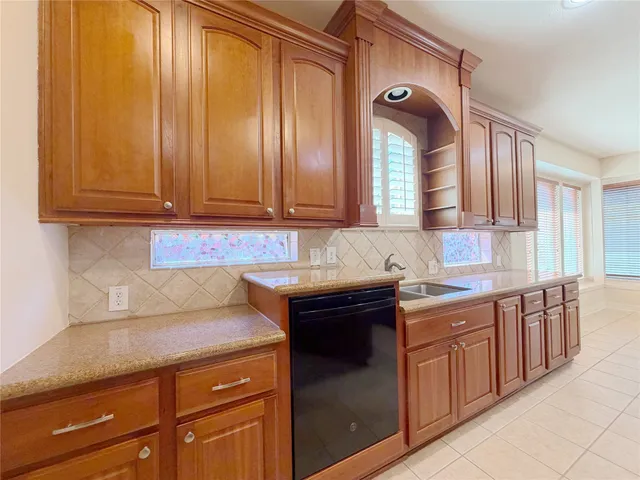 a kitchen with stainless steel appliances granite countertop cabinets and window