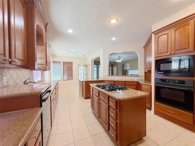 a kitchen with stainless steel appliances granite countertop a stove and a sink