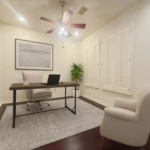 a living room with furniture and a potted plant
