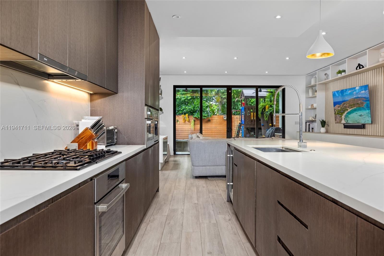 3222 Matilda Street, Unit 3222 Miami, FL 33133 - Photo 17 of 70 a kitchen with stainless steel appliances kitchen island a large window in it