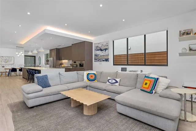 a living room with furniture and large windows