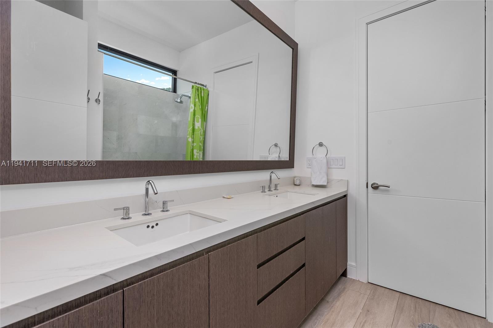 3222 Matilda Street, Unit 3222 Miami, FL 33133 - Photo 37 of 70 a bathroom with a double vanity sink and mirror