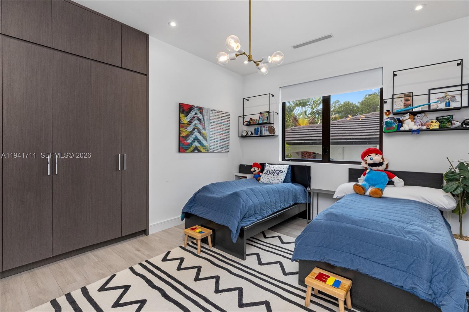 3222 Matilda Street, Unit 3222 Miami, FL 33133 - Photo 38 of 70 a living room with furniture a flat screen tv and kitchen view