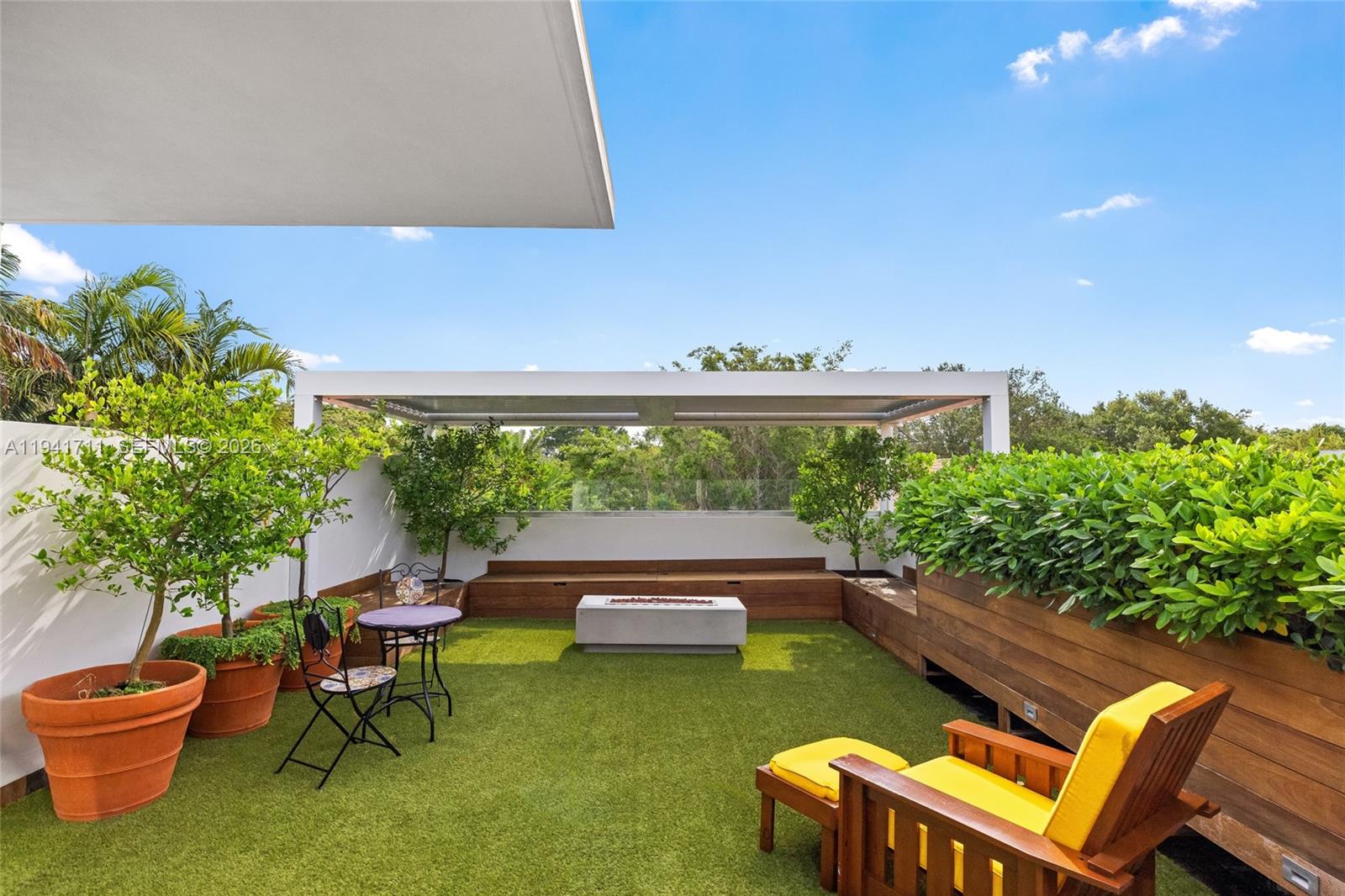 3222 Matilda Street, Unit 3222 Miami, FL 33133 - Photo 57 of 70 a backyard of a house with table and chairs