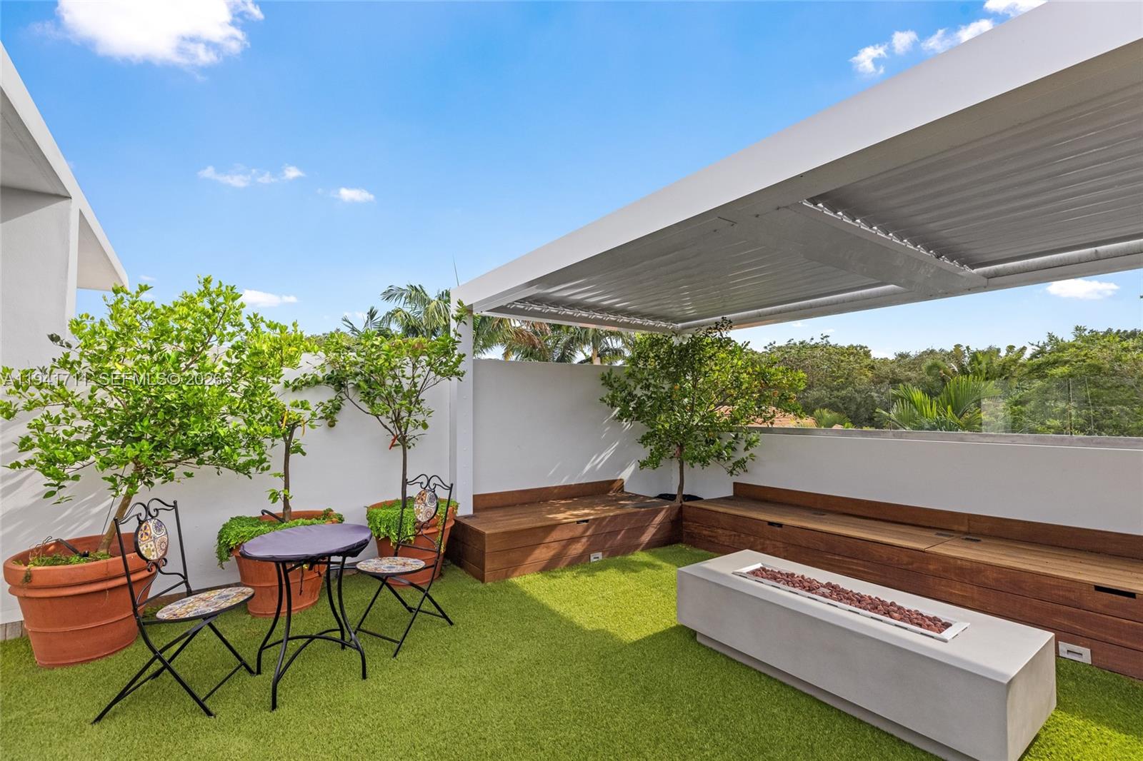 3222 Matilda Street, Unit 3222 Miami, FL 33133 - Photo 59 of 70 a backyard of a house with table and chairs