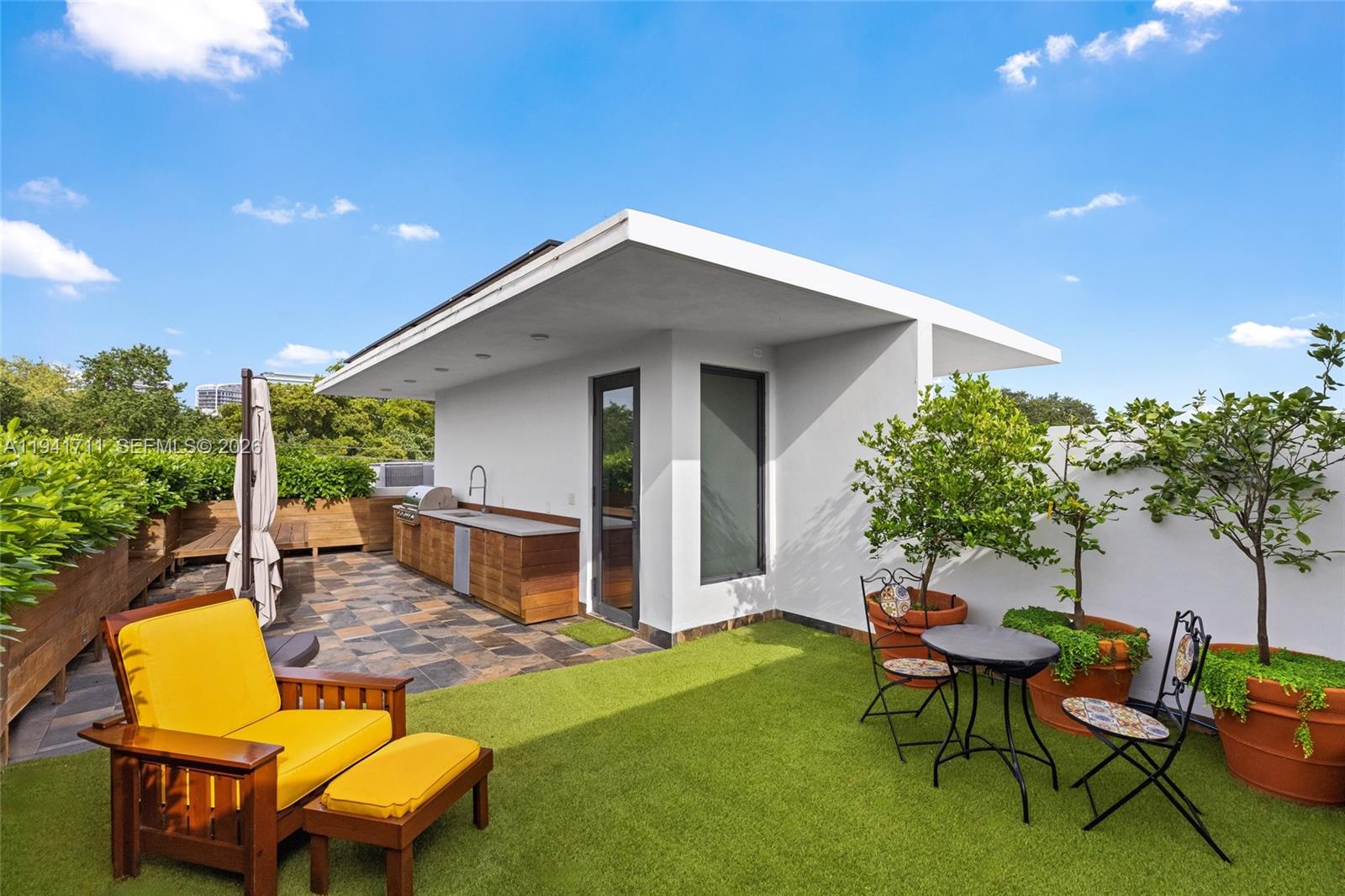 3222 Matilda Street, Unit 3222 Miami, FL 33133 - Photo 60 of 70 a backyard of a house with table and chairs