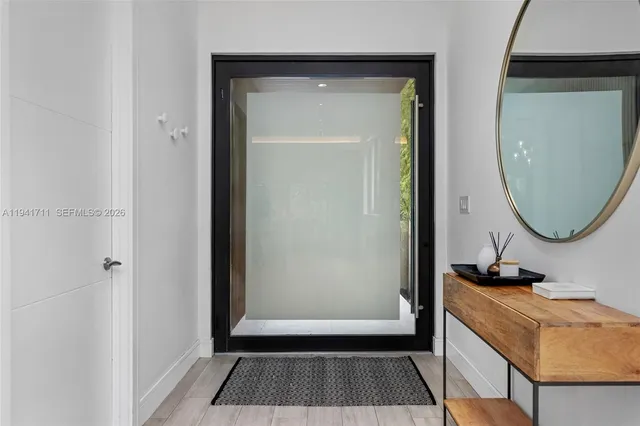 a open kitchen with stainless steel appliances kitchen island granite countertop a dining table chairs and granite counter tops