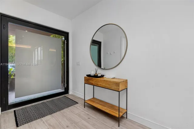 a kitchen with stainless steel appliances kitchen island granite countertop a refrigerator a sink and a stove