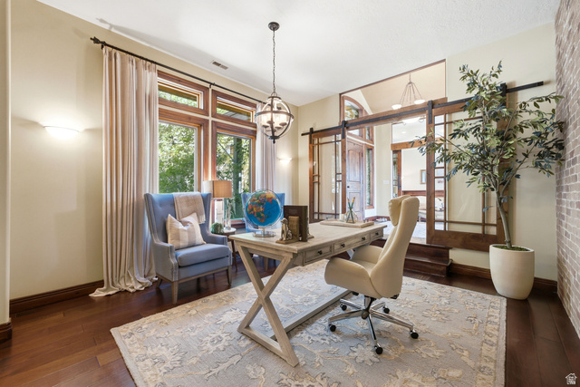335 Bern Way Midway, UT 84049 - Photo 11 of 88 Hardwood flooring with a patterned area rug, expansive windows with architectural wood trim, and a prominent globe pendant light fixture