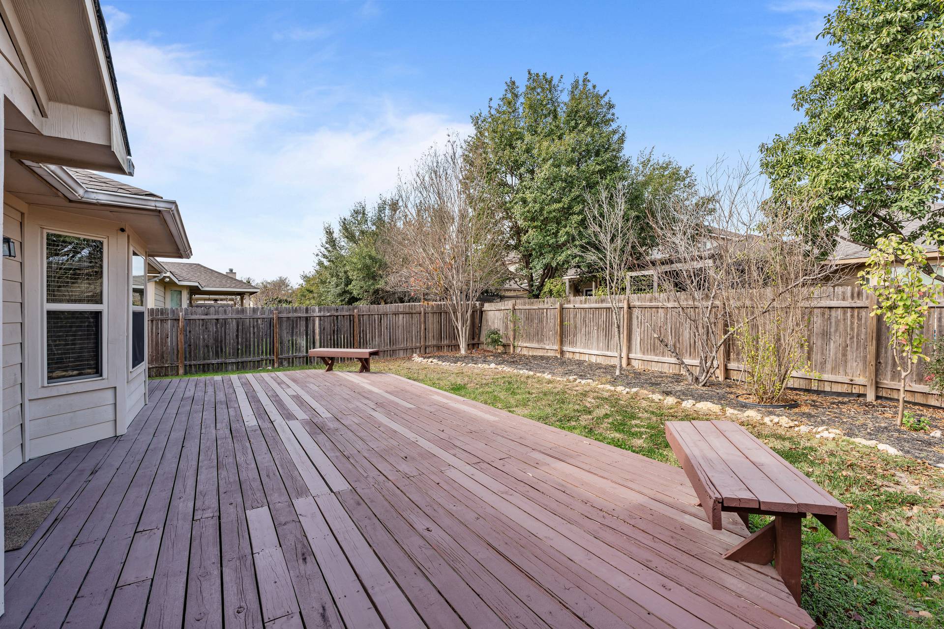 180 Fletcher Bend Buda, TX 78610 - Photo 29 of 36 a view of a wooden deck with a bench