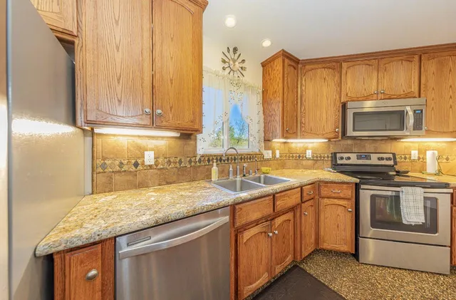 a living room with furniture and large windows