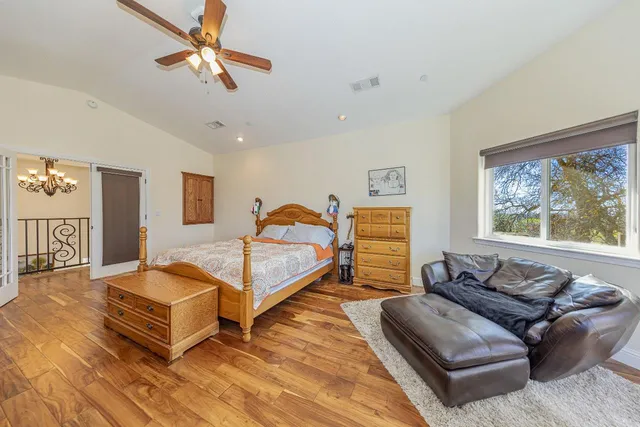 a bedroom with a bed and a mirror