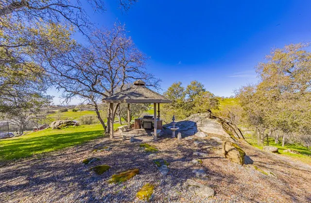 a kitchen with stainless steel appliances granite countertop a refrigerator a stove a sink and a refrigerator