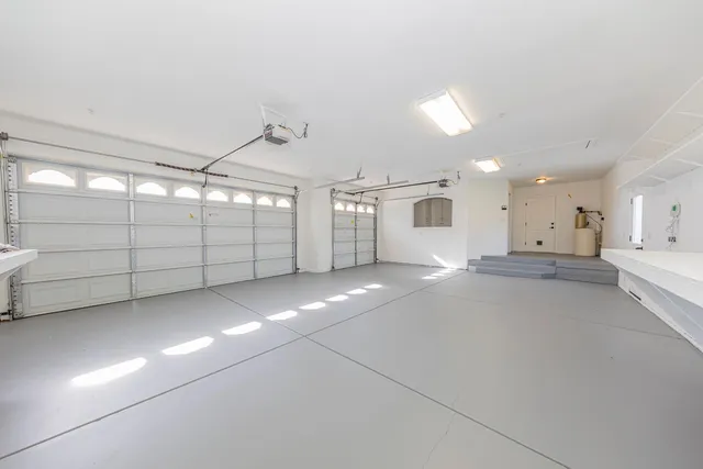 a bathroom with a granite countertop tub a double vanity sink and a mirror