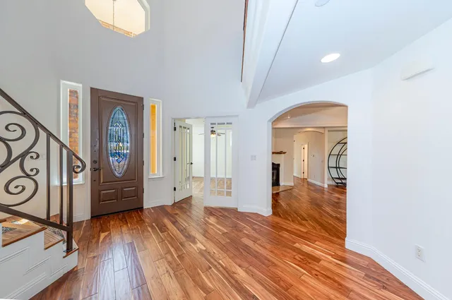 a bathroom with a white bath tub a mirror and a shower