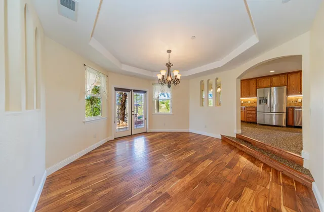 a bathroom with a granite countertop double vanity sink and a mirror