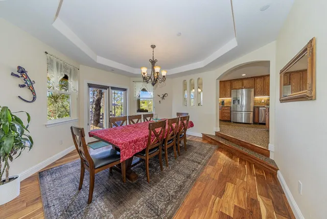 a view of a dining room with furniture and chandelier